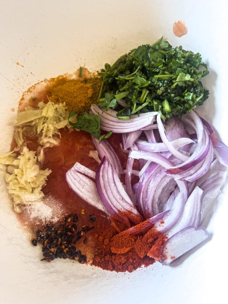 Transfer all seasoning, spices and vegetables to the bowl